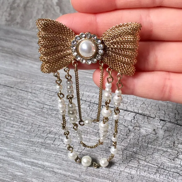 VINTAGE GOLD METAL DIAMANTE BOW BROOCH PIN WITH PEARL CHAIN